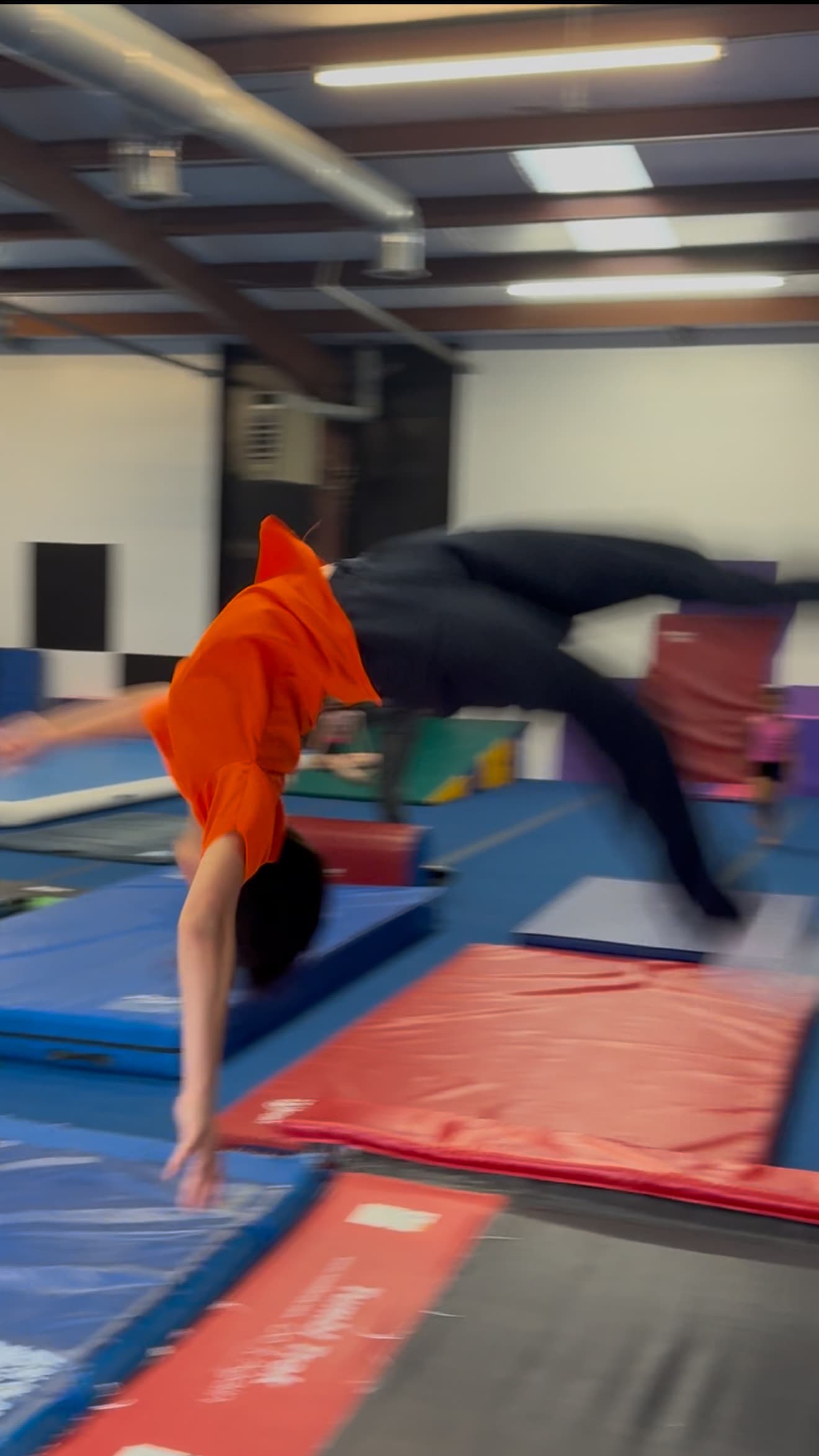 DFDub athletes mid-backflip at practice
